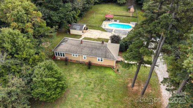an aerial view of a house with a yard basket ball court and outdoor seating