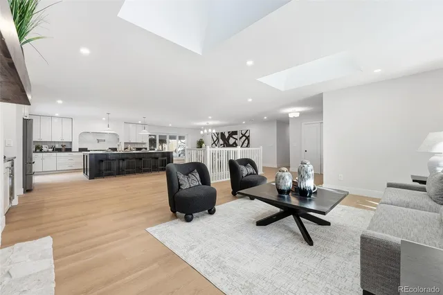 a living room with furniture and kitchen view