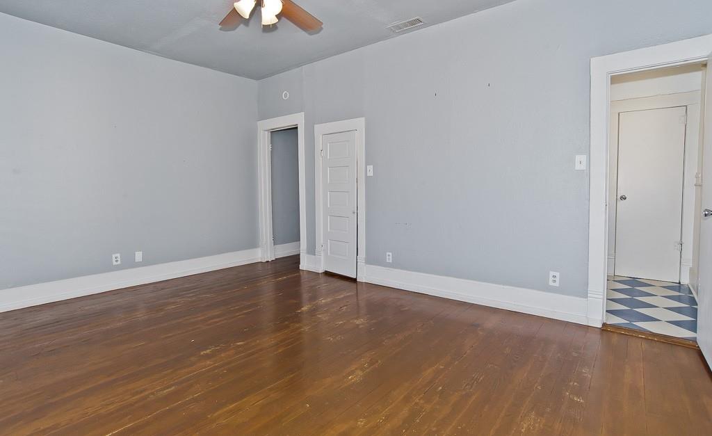 4910 Victor Street, Unit 4 Dallas, TX 75214 - Photo 12 of 24 a view of an empty room with wooden floor a ceiling fan and window