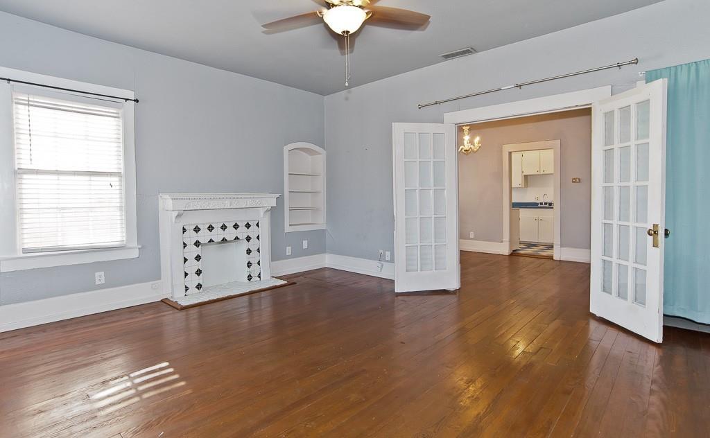 4910 Victor Street, Unit 4 Dallas, TX 75214 - Photo 18 of 24 a view of an empty room with wooden floor and a window