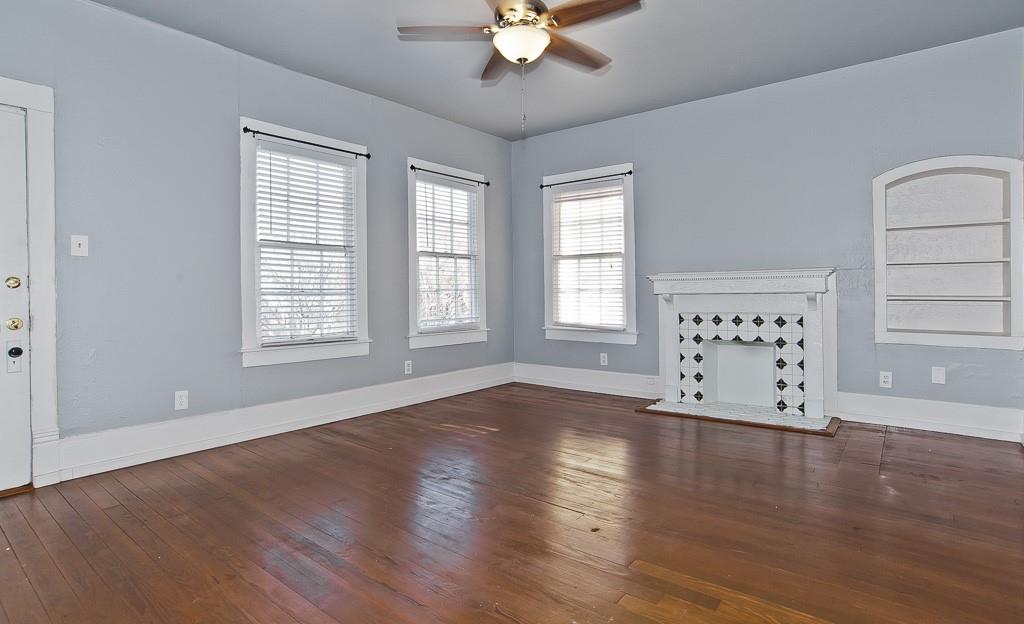 4910 Victor Street, Unit 4 Dallas, TX 75214 - Photo 2 of 24 an empty room with wooden floor chandelier fan and windows