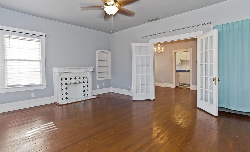 4910 Victor Street, Unit 4 Dallas, TX 75214 - Photo 3 of 24 a view of an empty room with wooden floor and a window