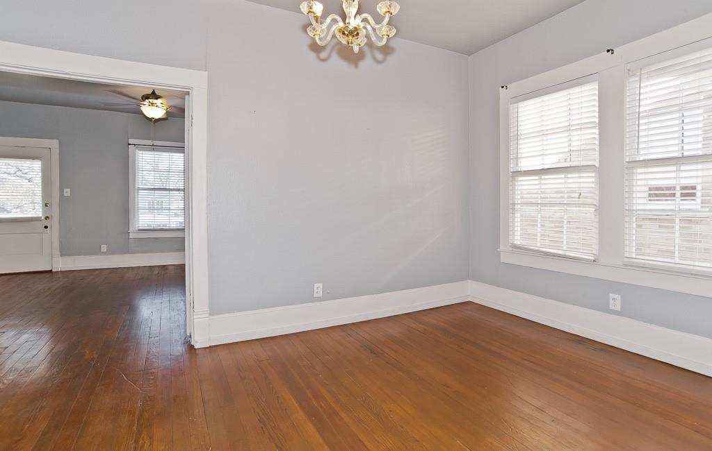 4910 Victor Street, Unit 4 Dallas, TX 75214 - Photo 5 of 24 an empty room with wooden floor and windows