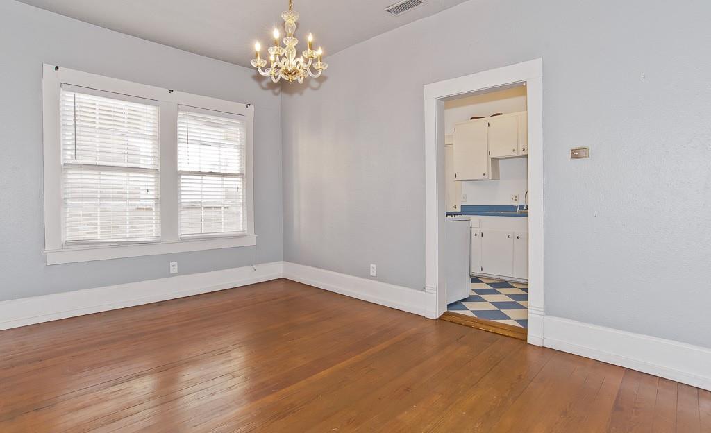 4910 Victor Street, Unit 4 Dallas, TX 75214 - Photo 6 of 24 an empty room with wooden floor and windows