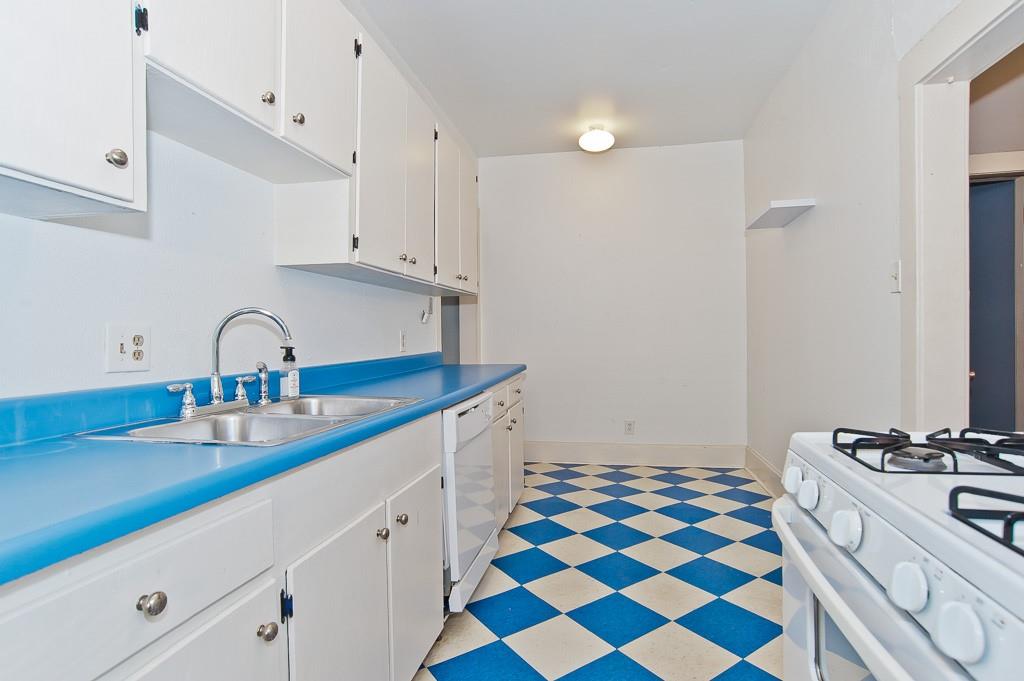 4910 Victor Street, Unit 4 Dallas, TX 75214 - Photo 7 of 24 a kitchen with a sink and a stove top oven