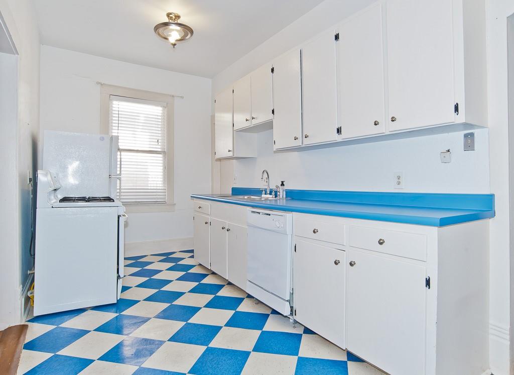4910 Victor Street, Unit 4 Dallas, TX 75214 - Photo 8 of 24 a kitchen with granite countertop white cabinets and appliances