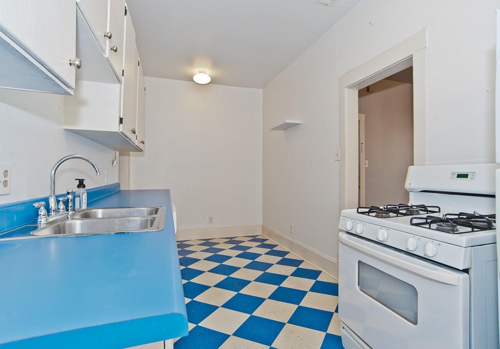 4910 Victor Street, Unit 4 Dallas, TX 75214 - Photo 10 of 24 a kitchen with granite countertop cabinets a stove and a sink