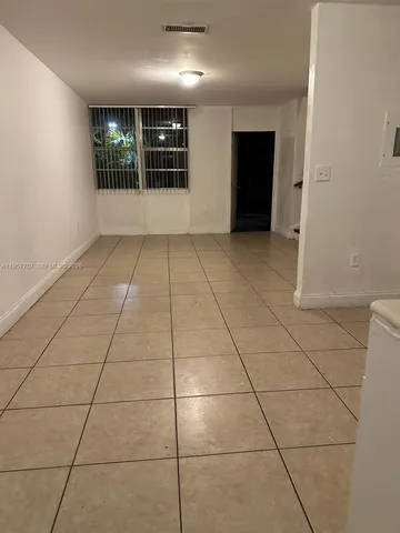 a view of an empty room with windows