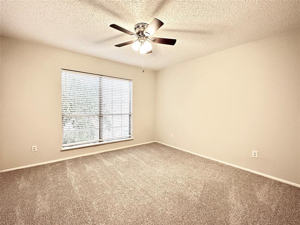 3801 14th Street, Unit 2305 Plano, TX 75074 - Photo 12 of 16 an empty room with chandelier fan and windows