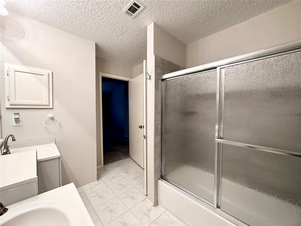 3801 14th Street, Unit 2305 Plano, TX 75074 - Photo 13 of 16 a bathroom with a shower and a sink