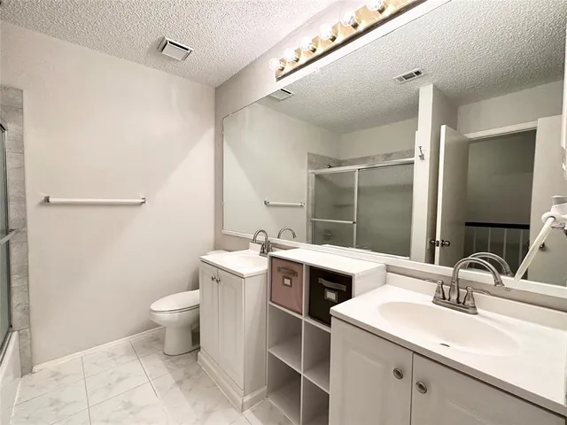 a bathroom with a sink toilet and mirror
