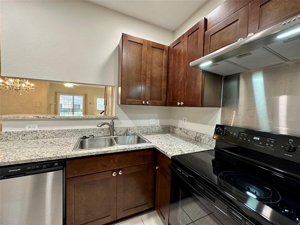 3801 14th Street, Unit 2305 Plano, TX 75074 - Photo 8 of 16 a kitchen with a sink a stove and cabinets