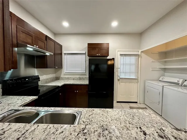 a kitchen that has a sink and a stove in it