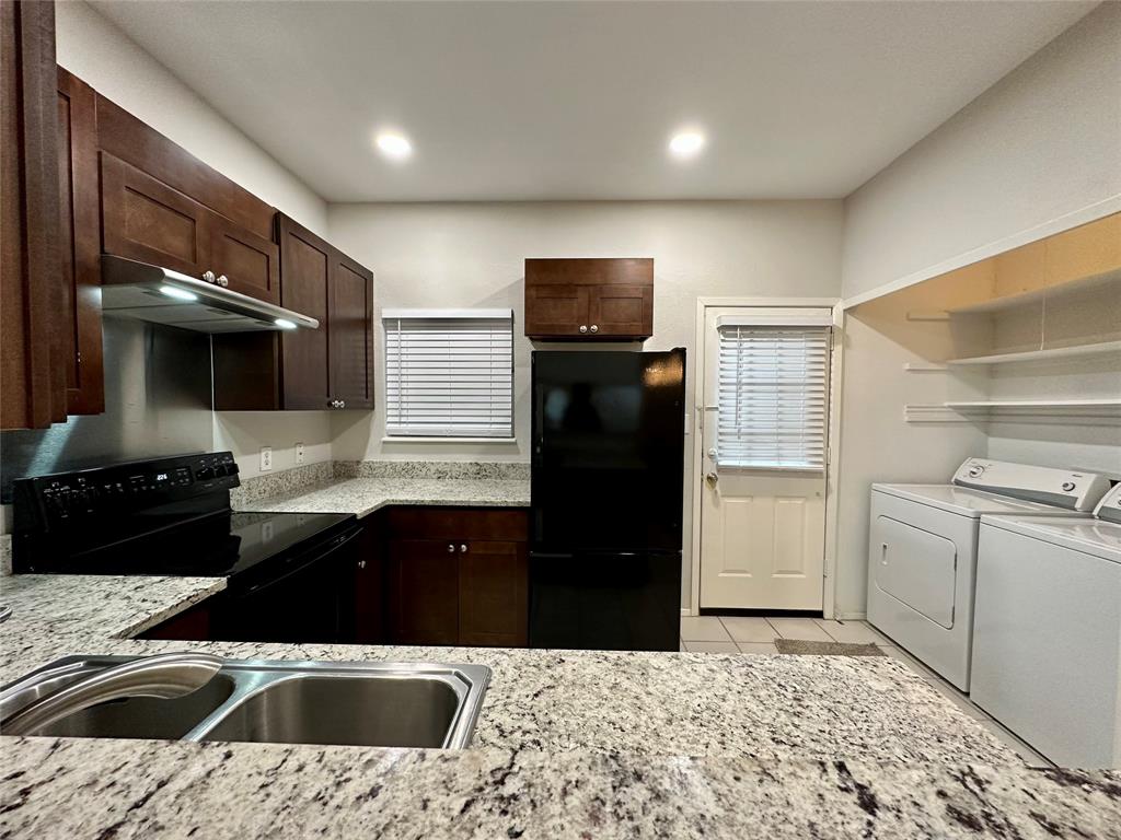 3801 14th Street, Unit 2305 Plano, TX 75074 - Photo 9 of 16 a kitchen that has a sink and a stove in it