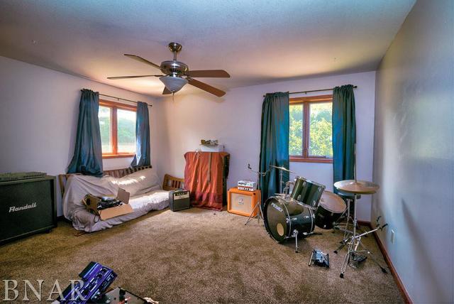 9537 Tabor Road Clinton, IL 61727 - Photo 12 of 17 a living room with furniture a window and gym equipment