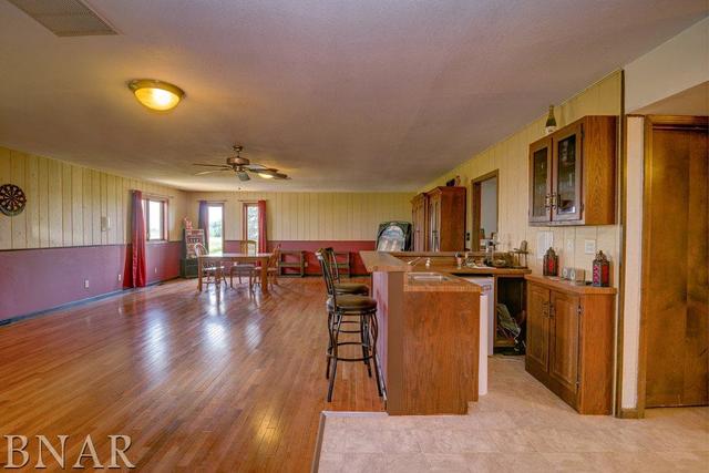 9537 Tabor Road Clinton, IL 61727 - Photo 6 of 17 a dining hall with couches chairs and wooden floor