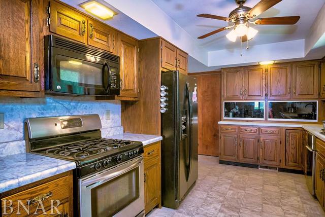 9537 Tabor Road Clinton, IL 61727 - Photo 7 of 17 a kitchen with kitchen island granite countertop a stove and a refrigerator