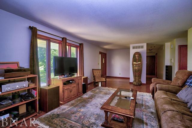 9537 Tabor Road Clinton, IL 61727 - Photo 8 of 17 a living room with furniture and a flat screen tv