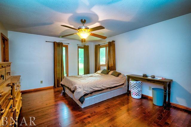 9537 Tabor Road Clinton, IL 61727 - Photo 10 of 17 a bedroom with a bed and wooden floors