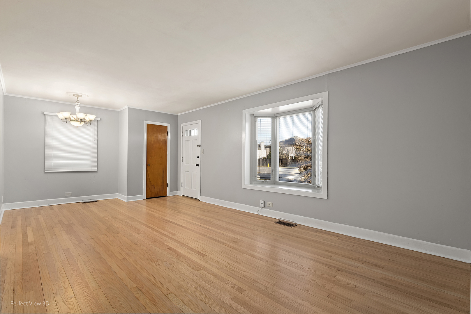 603 West Rand Road Mount Prospect, IL 60056 - Photo 3 of 20 a view of an empty room with window and wooden floor