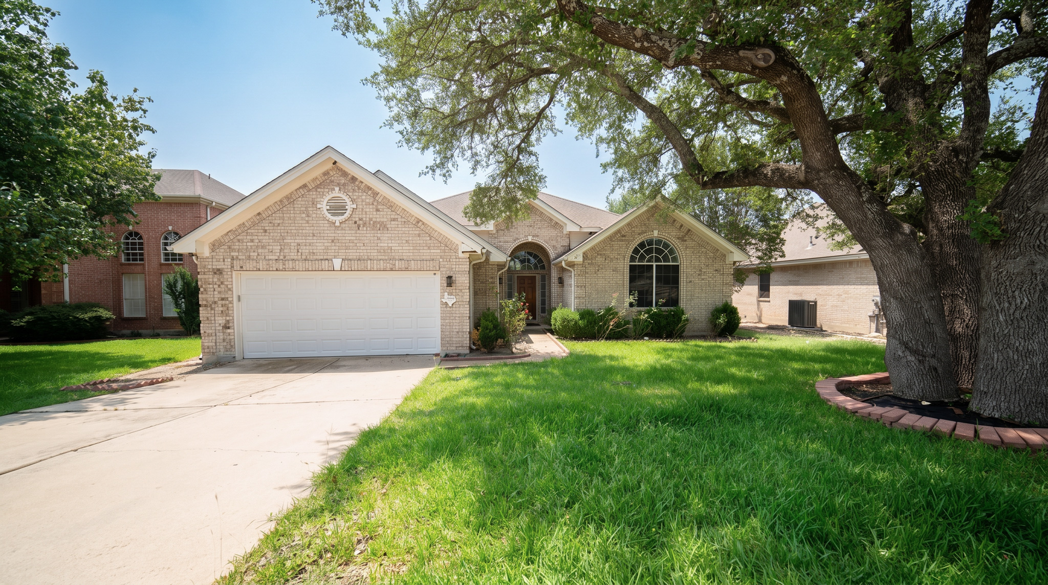 1108 Antelope Ridge Cedar Park, TX 78613 - Photo 2 of 27 Elegant brick facade with arched windows and a lush front lawn provide welcoming curb appeal.
