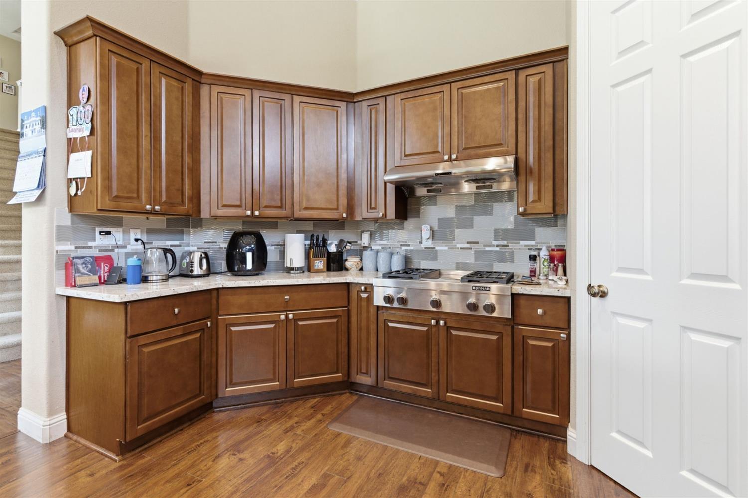 848 West Santos Avenue Ripon, CA 95366 - Photo 19 of 63 a kitchen with stainless steel appliances granite countertop a stove a sink and a refrigerator