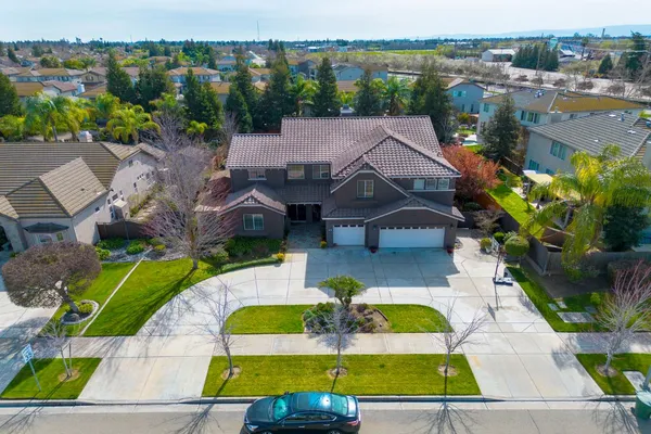 an aerial view of a house with a swimming pool outdoor seating and yard