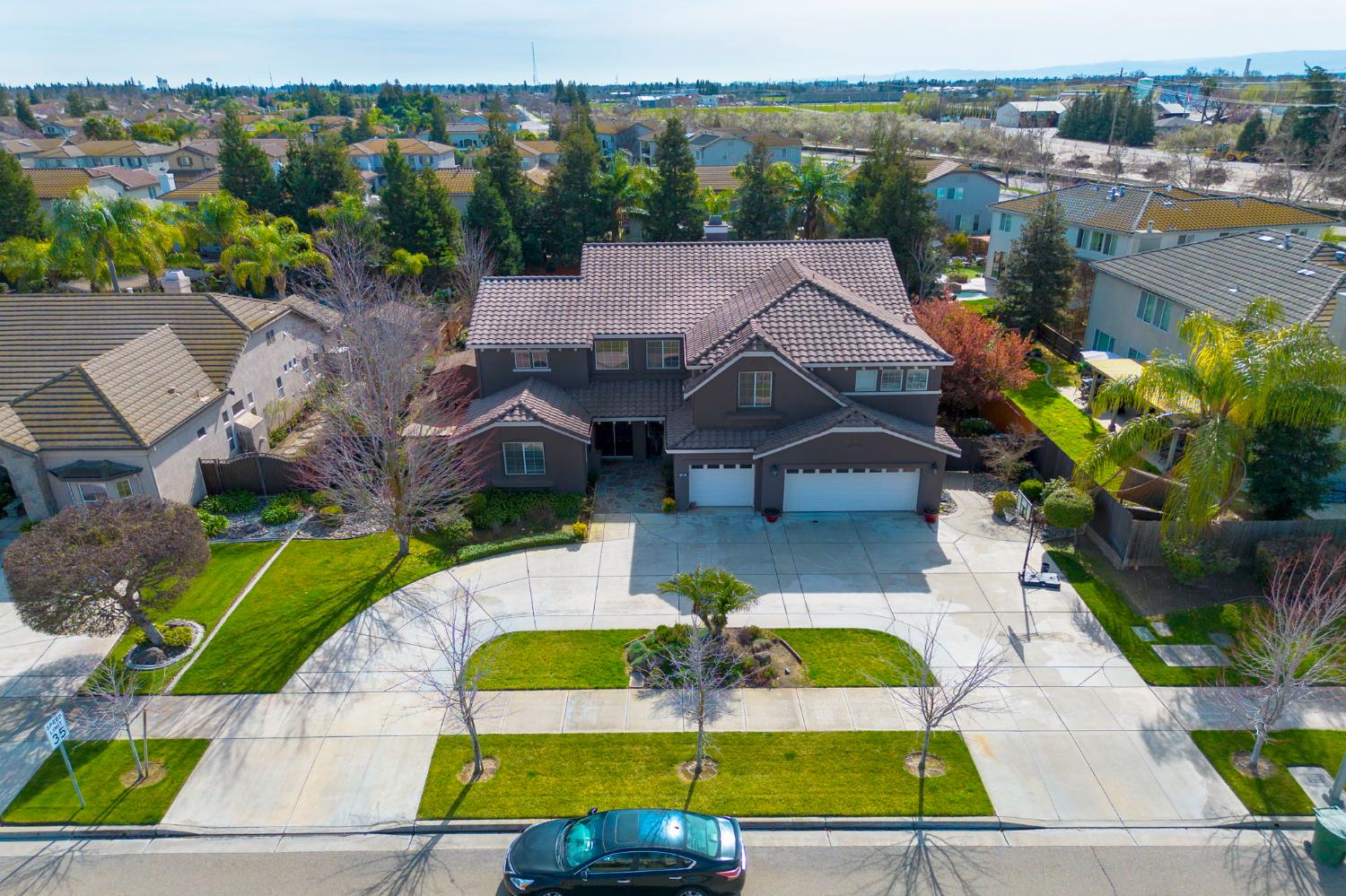 848 West Santos Avenue Ripon, CA 95366 - Photo 2 of 63 an aerial view of a house with a swimming pool outdoor seating and yard