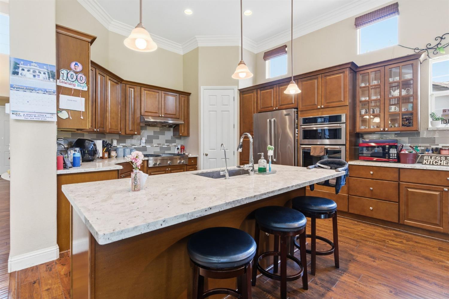 848 West Santos Avenue Ripon, CA 95366 - Photo 23 of 63 a kitchen with a table chairs sink and cabinets