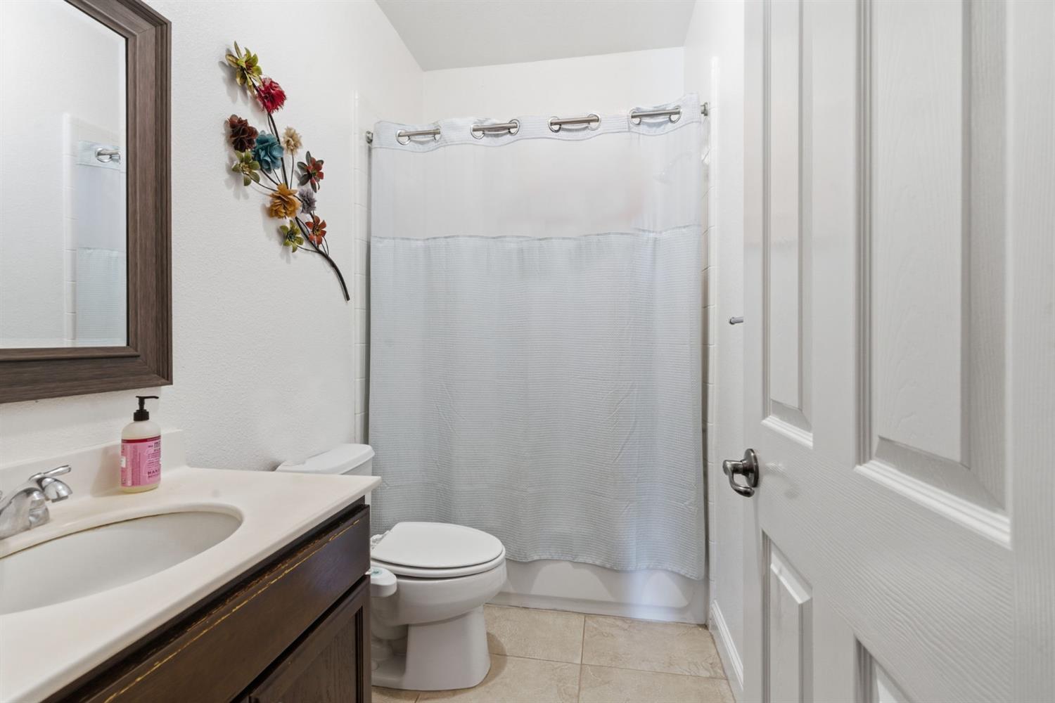 848 West Santos Avenue Ripon, CA 95366 - Photo 27 of 63 a bathroom with a sink vanity mirror and toilet