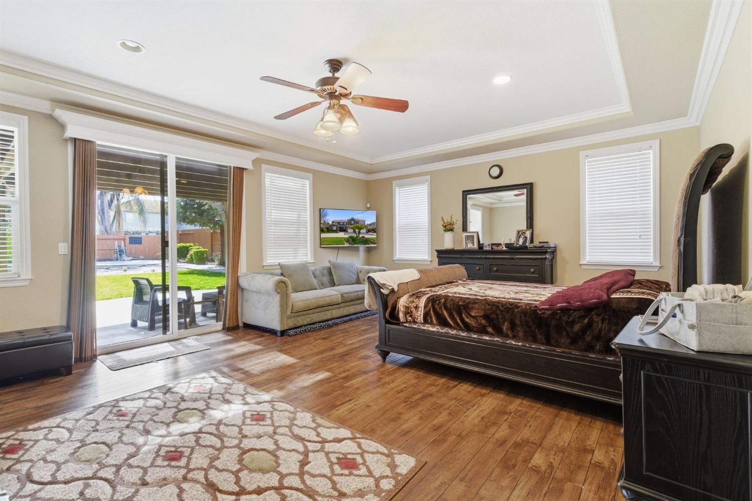 848 West Santos Avenue Ripon, CA 95366 - Photo 32 of 63 a spacious bedroom with a bed a couch and a window