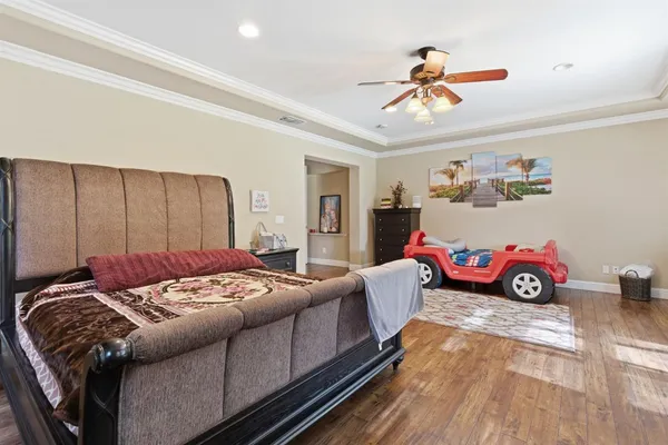 a bedroom with a bed and a chandelier