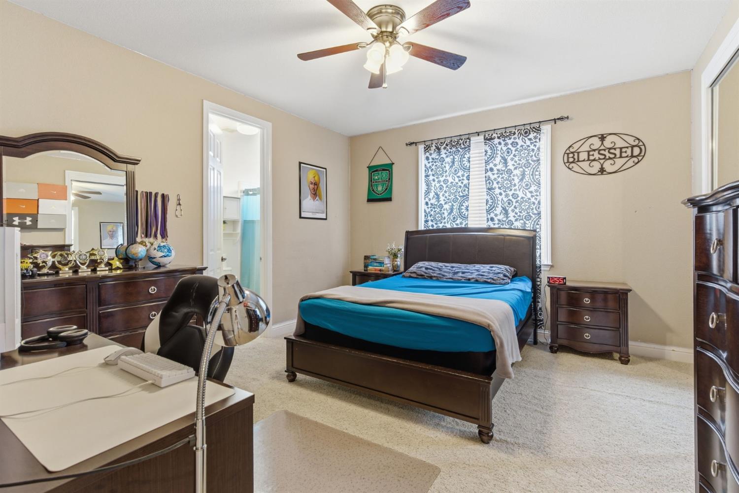 848 West Santos Avenue Ripon, CA 95366 - Photo 39 of 63 a bedroom with a bed and a chandelier