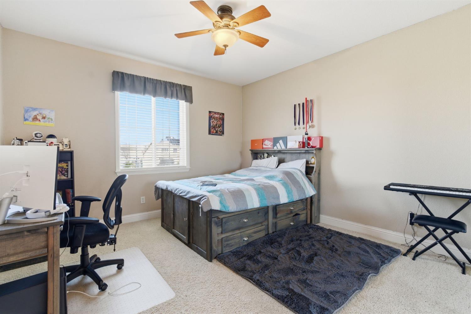 848 West Santos Avenue Ripon, CA 95366 - Photo 43 of 63 a bedroom with a bed a desk and chair with wooden floor