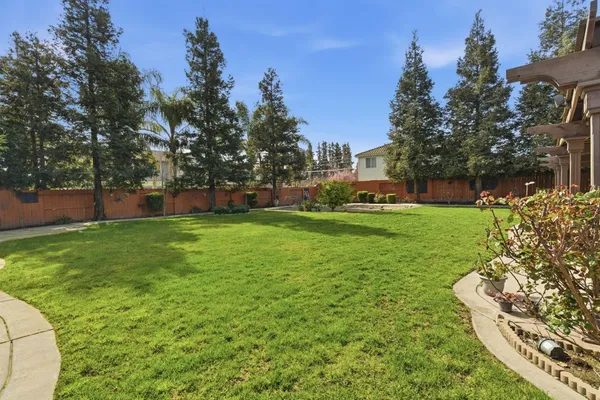 an aerial view of a house with a yard and garden