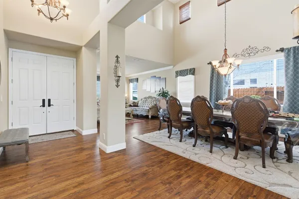 a living room with furniture a table and a chandelier