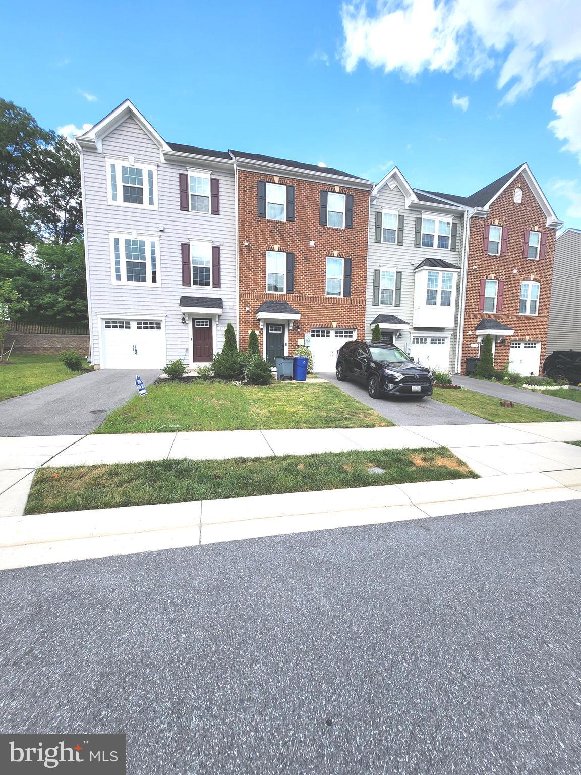 a view of a big house with a yard and plants
