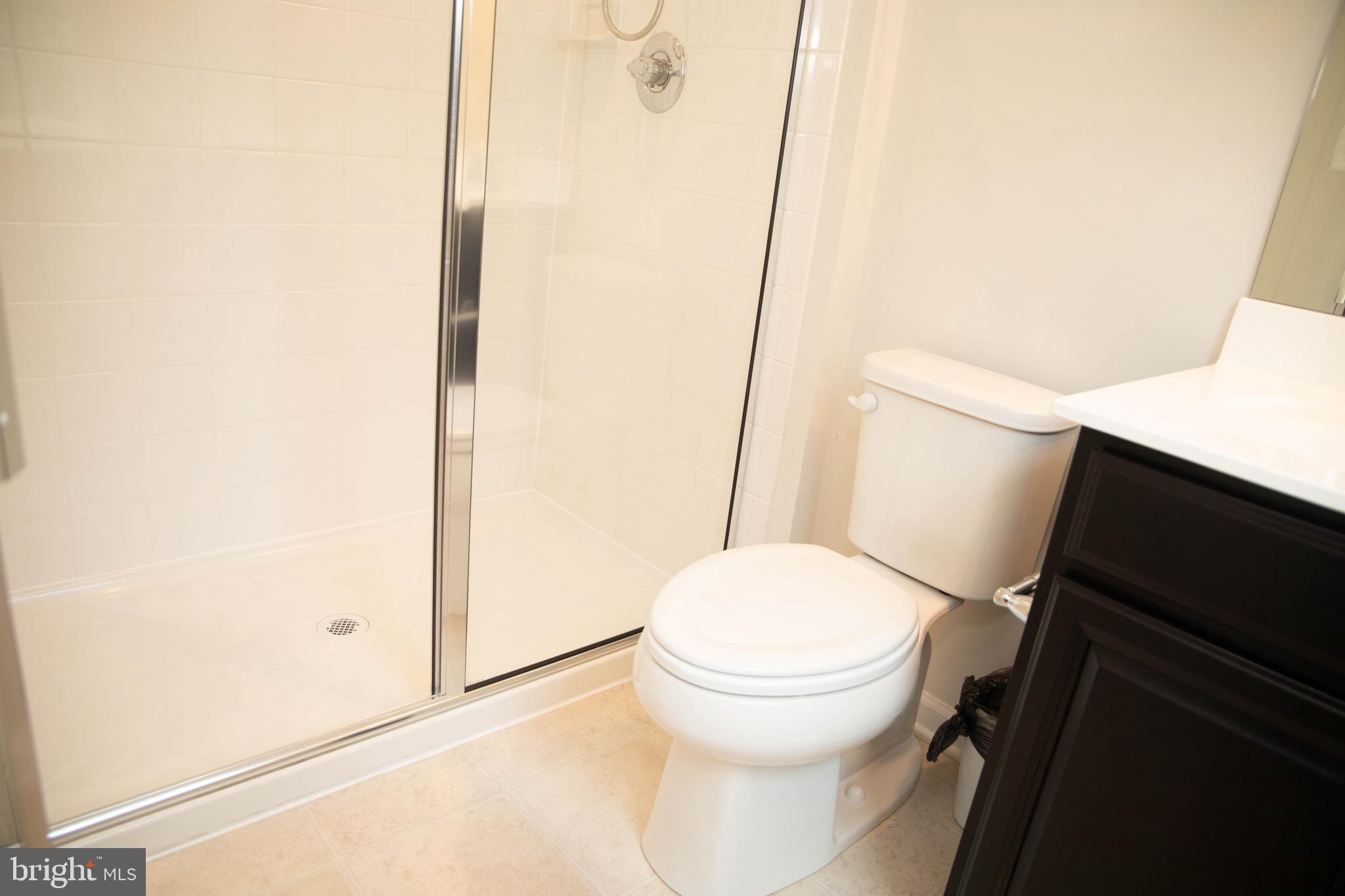 1813 Wind Gate Road Baltimore, MD 21227 - Photo 13 of 27 a white toilet sitting next to a shower