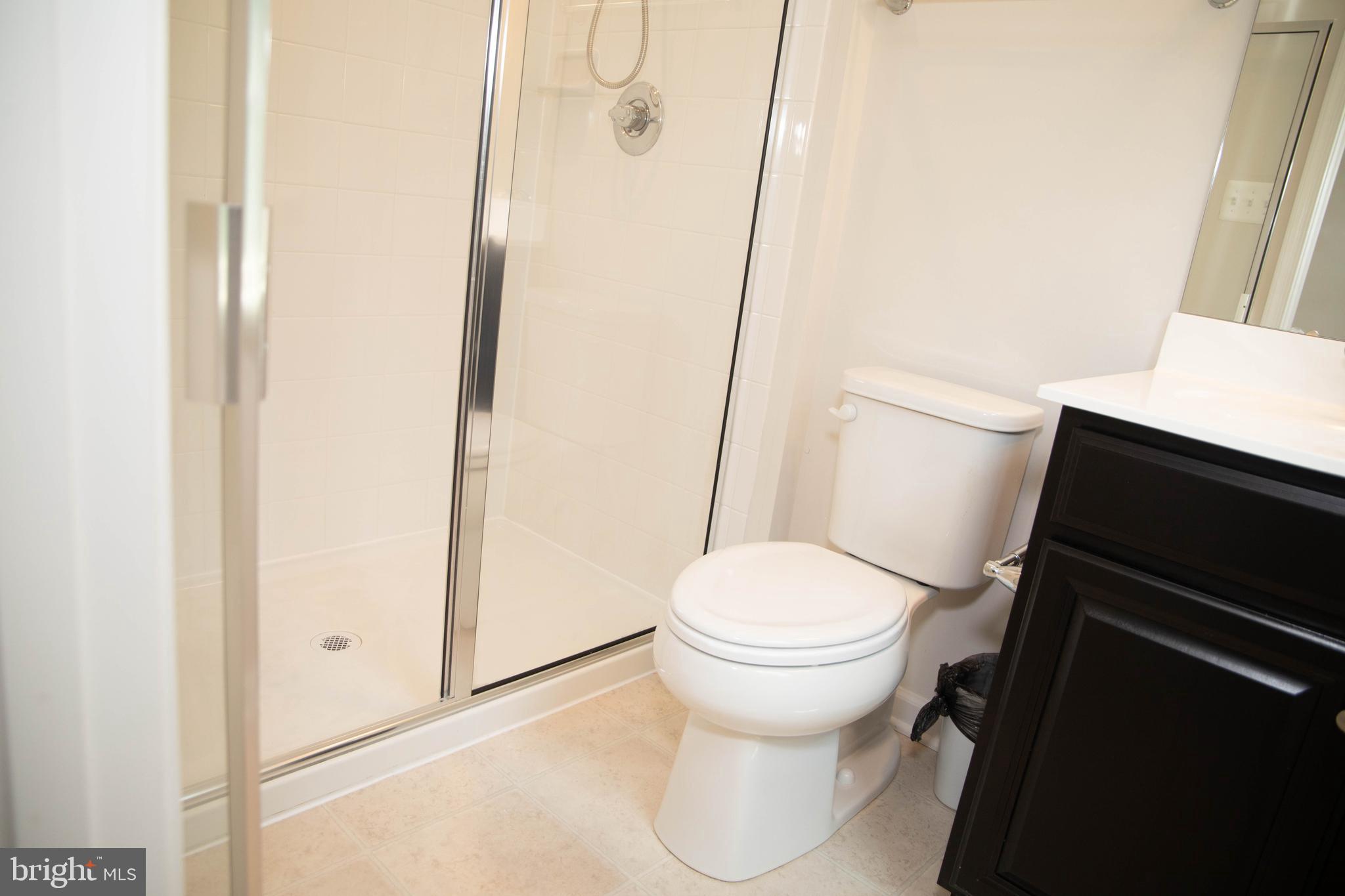 1813 Wind Gate Road Baltimore, MD 21227 - Photo 14 of 27 a white toilet sitting next to a shower