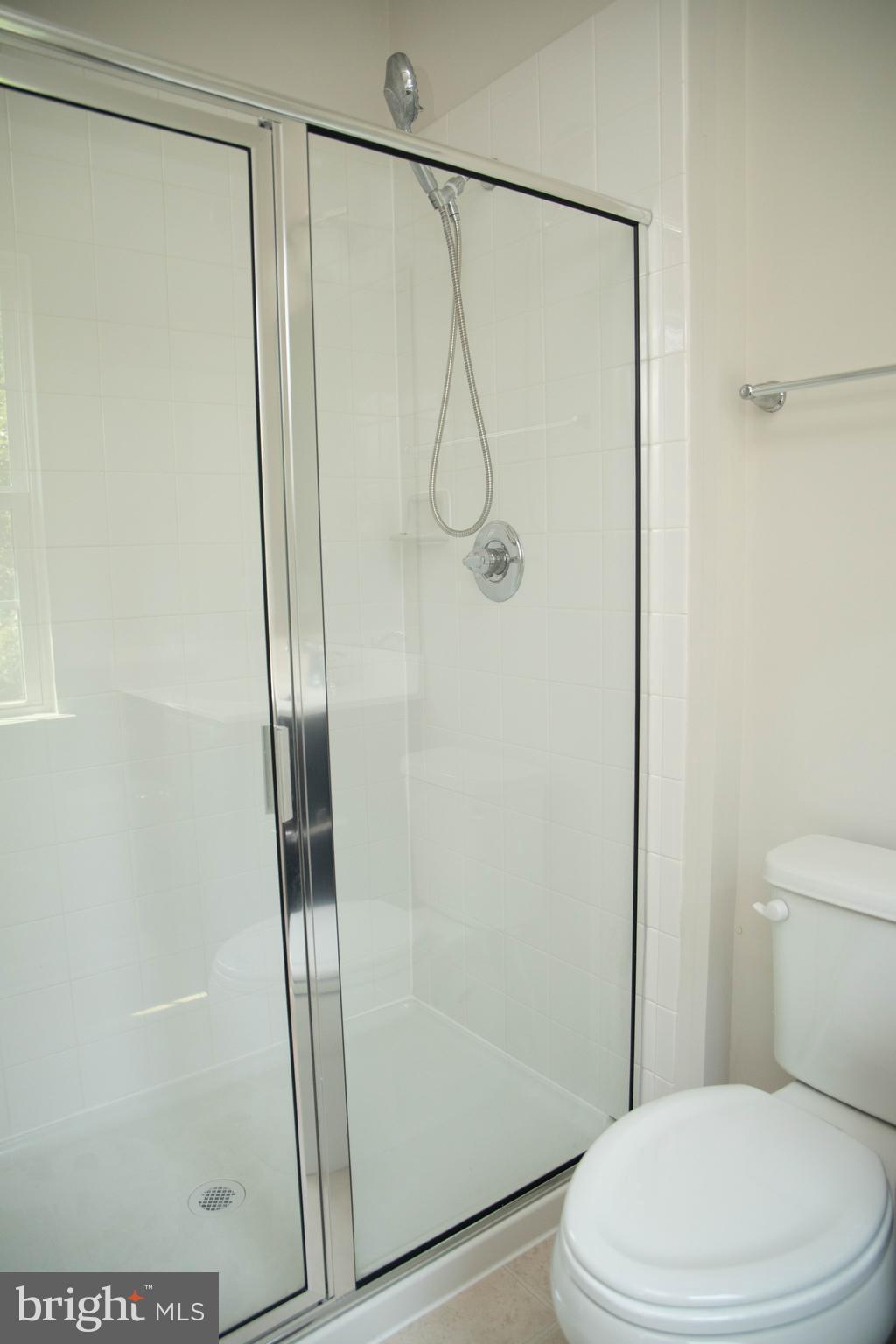 1813 Wind Gate Road Baltimore, MD 21227 - Photo 15 of 27 a bathroom with a glass shower door