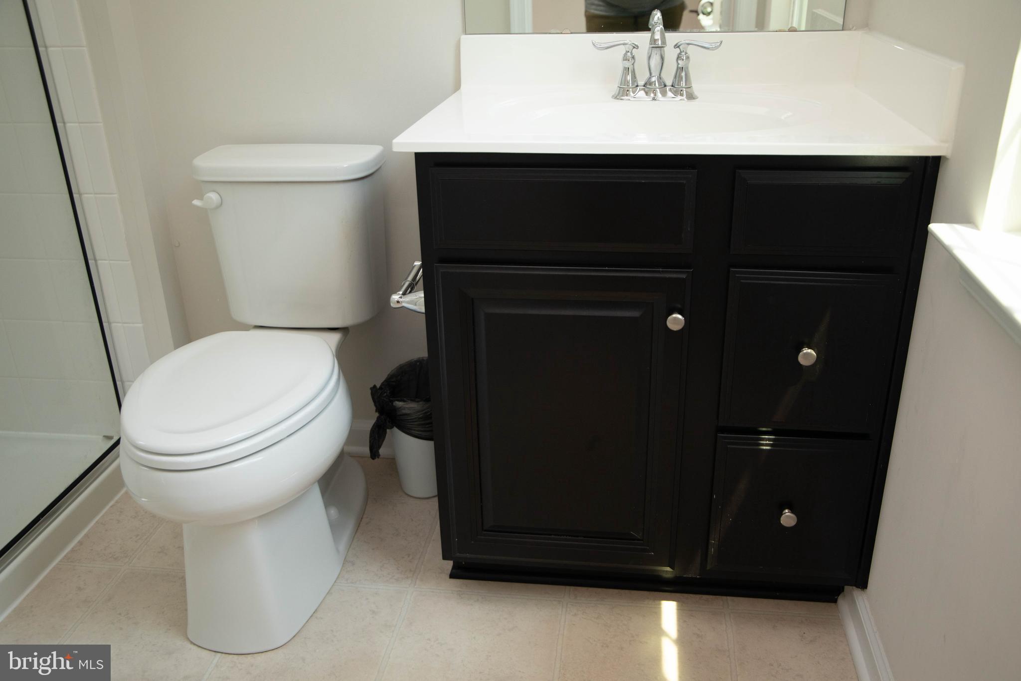1813 Wind Gate Road Baltimore, MD 21227 - Photo 16 of 27 a bathroom with a sink toilet and mirror