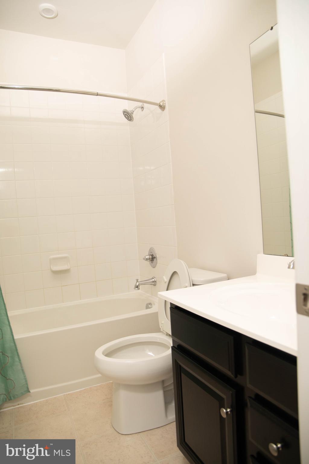 1813 Wind Gate Road Baltimore, MD 21227 - Photo 22 of 27 a bathroom with a sink a toilet and shower