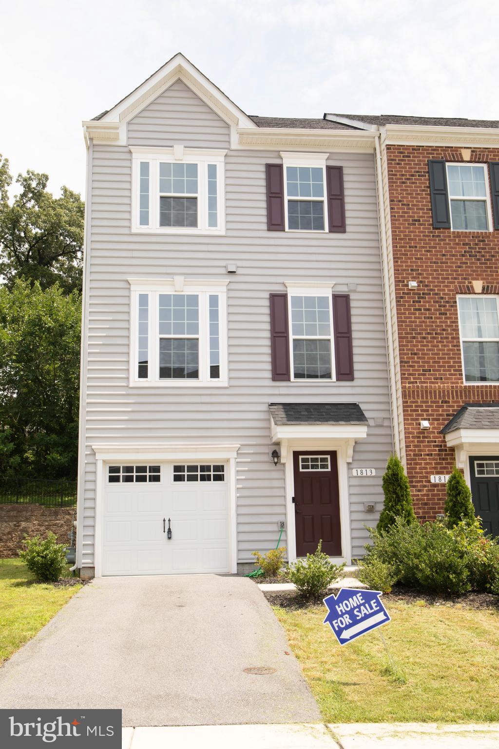 1813 Wind Gate Road Baltimore, MD 21227 - Photo 5 of 27 a front view of a house with garden