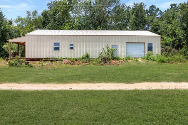 a aerial view of a house and a yard and trees