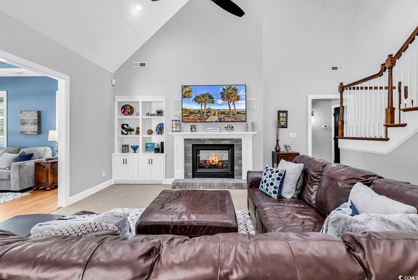 2441 Hunters Trail Myrtle Beach, SC 29588 - Photo 4 of 40 Living room featuring high vaulted ceiling, a bric