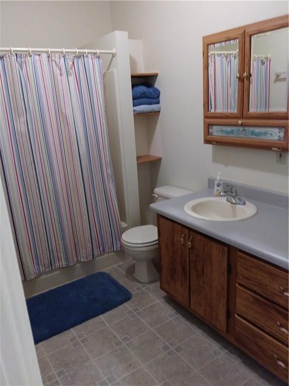 8801 Mull Road Vale, NC 28168 - Photo 21 of 36 a bathroom with a sink a toilet and mirror
