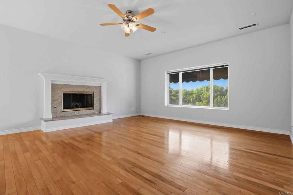 2596 Green Canyon Road Fallbrook, CA 92028 - Photo 22 of 74 a view of an empty room with wooden floor and a window