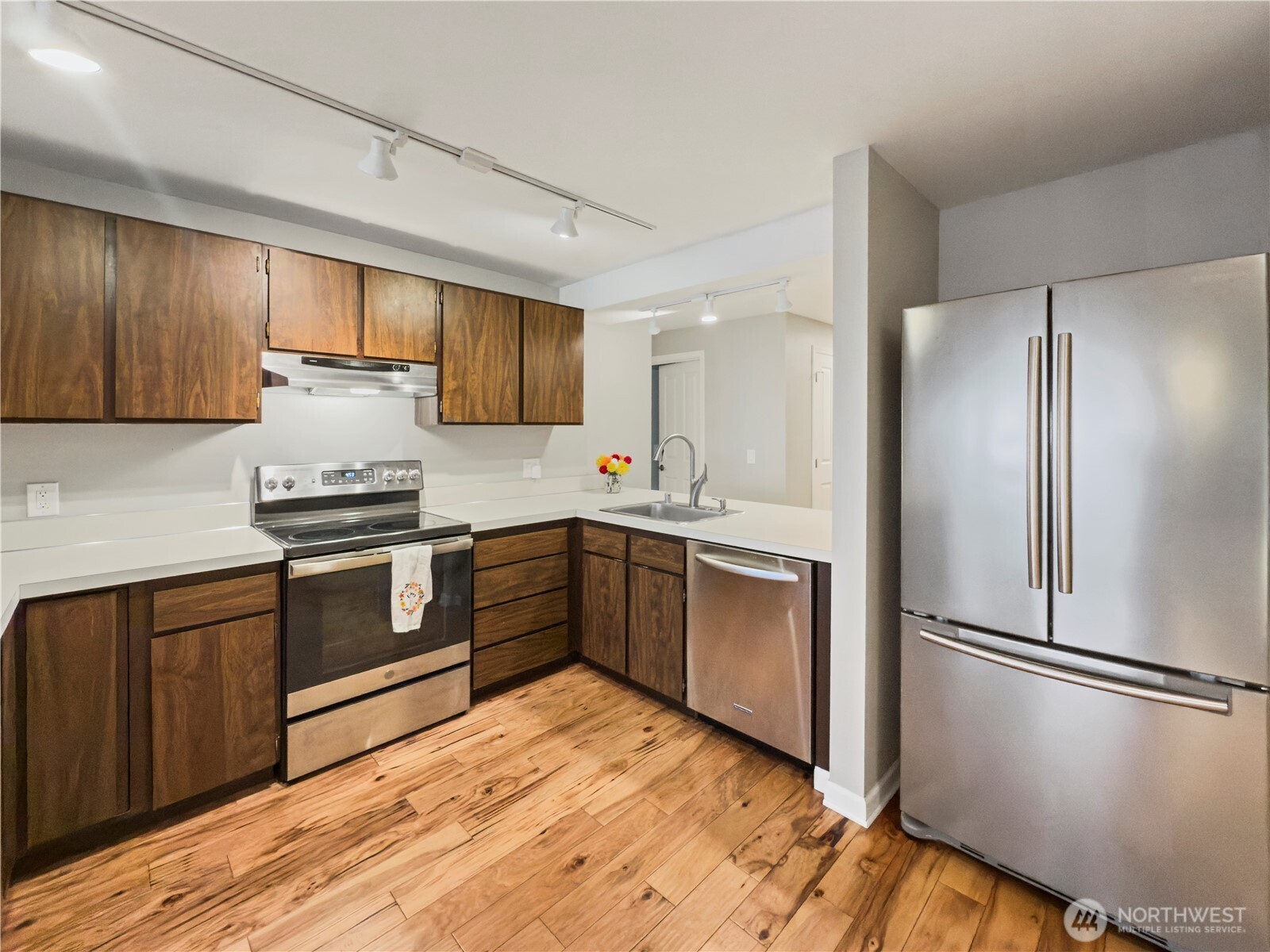 444 South State Street, Unit 307 Bellingham, WA 98225 - Photo 11 of 34 a kitchen with granite countertop stainless steel appliances a refrigerator sink and cabinets
