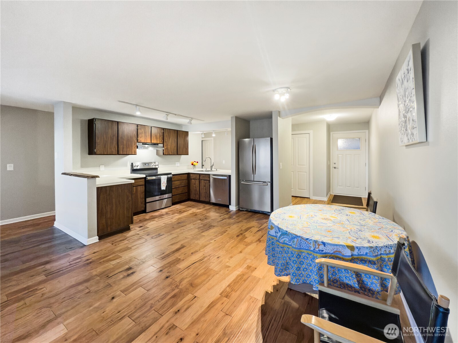 444 South State Street, Unit 307 Bellingham, WA 98225 - Photo 12 of 34 a open kitchen with kitchen island stainless steel appliances and wooden cabinets