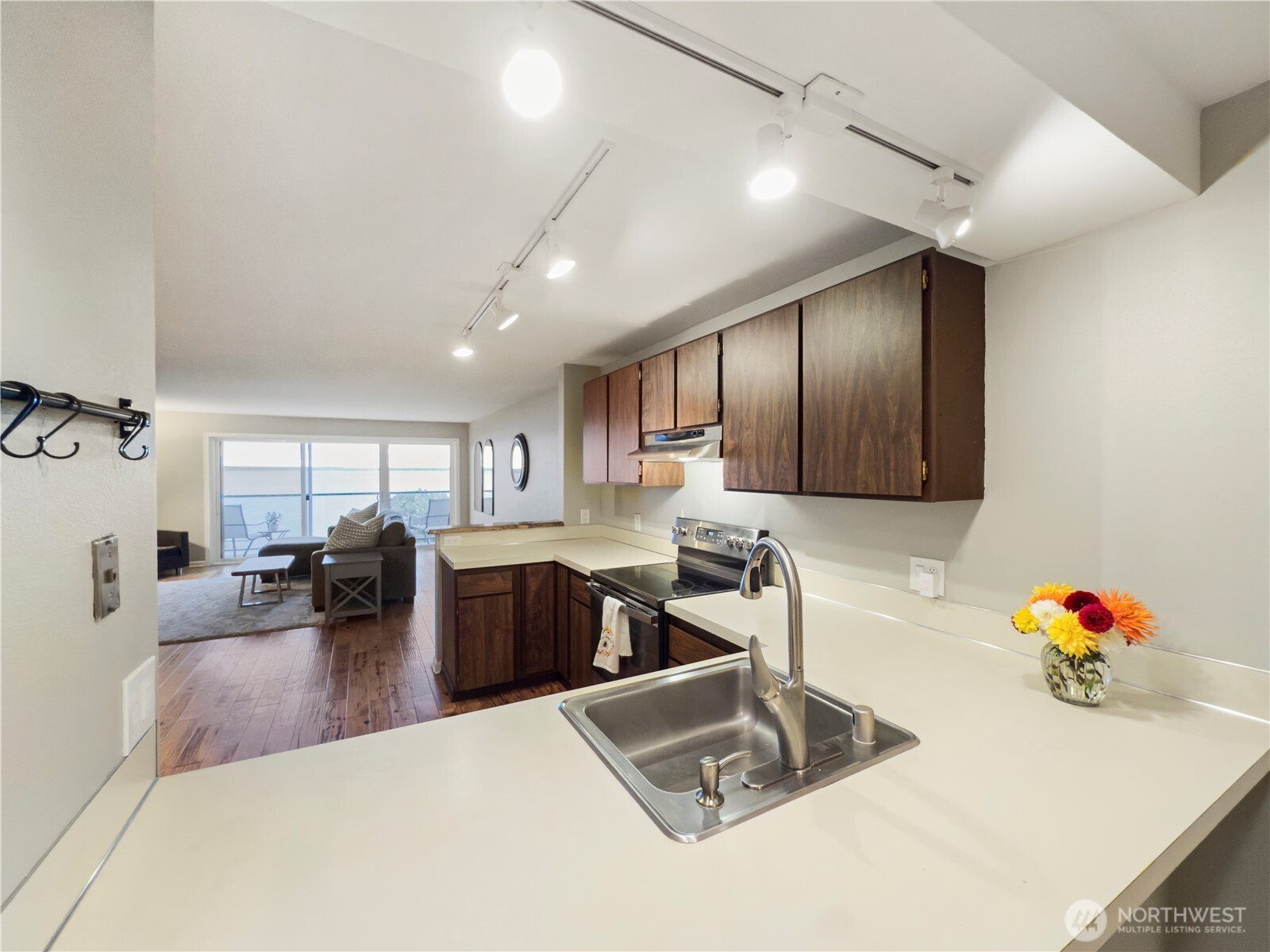 444 South State Street, Unit 307 Bellingham, WA 98225 - Photo 13 of 34 a living room with furniture kitchen view and a chandelier